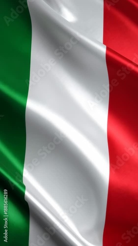 Close up of a silk Italian flag waving gently, displaying vibrant green, white and red colors, with soft fabric folds and shadows.