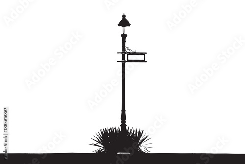 A black silhouette of a lamp post with a birdhouse on a white background