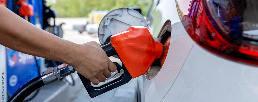 Fototapeta premium Man Refill and filling Oil Gas Fuel at station. Gas station - refueling.