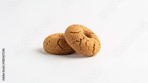 Fresh baked golden brown bagels stacked close-up minimalist white background