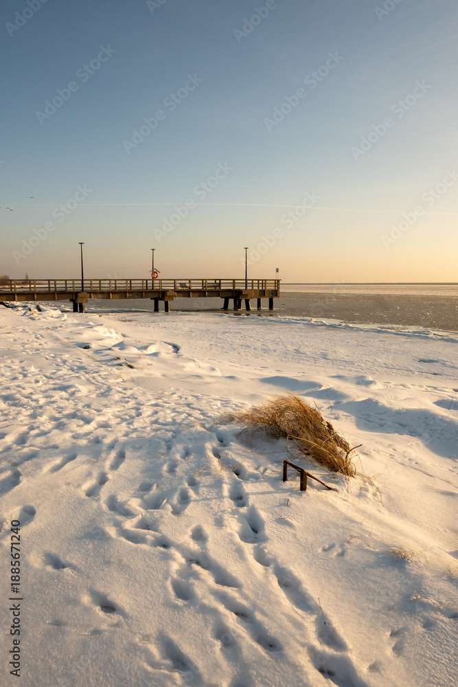 Fototapeta premium Winter coastline of Hel Peninsula with frozen Baltic Sea. Kuznica village in Poland, Europe