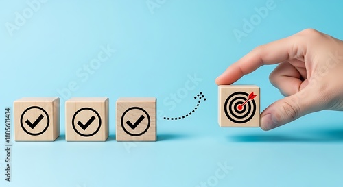 Human hand aligning a goal block with a series of checkmarks to symbolize successful project management and completion.