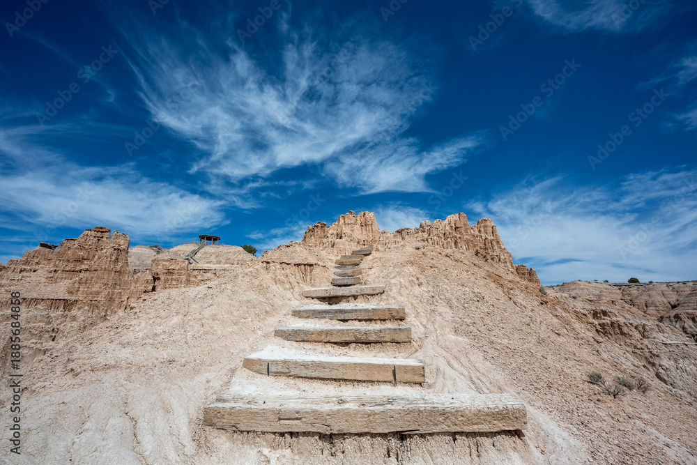 Fototapeta premium Blue skies over rocky desert steps exiting the Cathedral Gorge in Nevada 
