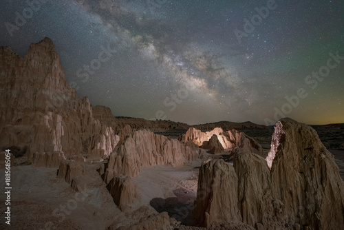 Illuminated desert rock formations in Nevada under a clear starry night sky 