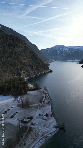 snow covered mountain lake achensee in austria with pertisau winter landscape vertical