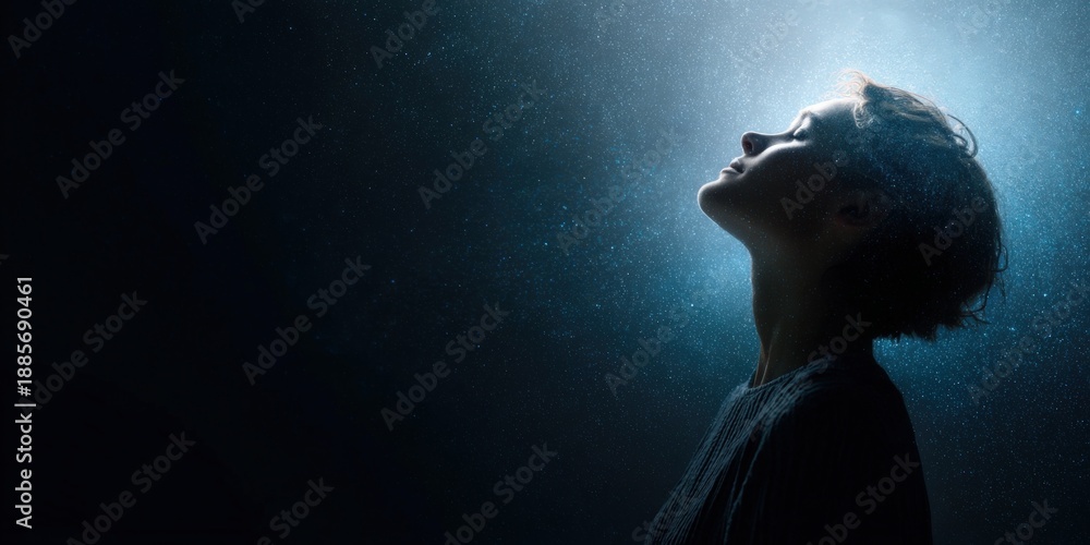 Fototapeta premium Young caucasian female gazing upward in starry night sky