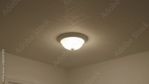 Realistic Video of a Flickering Ceiling Light Fixture in a Dim Room, Concept of Electrical Problems, Haunted House, or Bad Wiring
