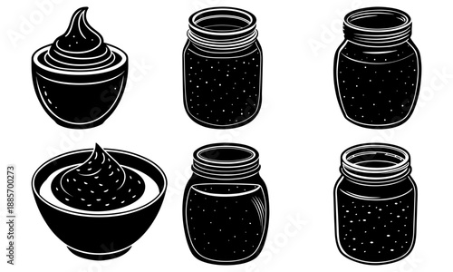 Blackberry jam in jars and a bowl on a clean white surface