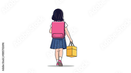 Back view of a young school girl with long dark hair wearing a backpack and carrying a bag as she walks toward her school building.