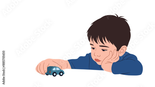 Sad little boy leaning on his hand and looking down with a melancholy expression while playing with a small blue toy car.