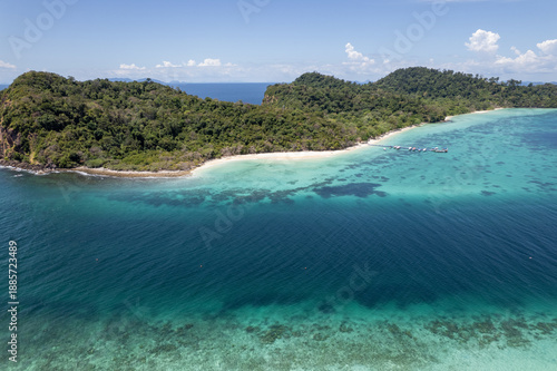 Tropical paradise white sand beach with palm trees on Koh Rok, Mu Ko Lanta National Park.