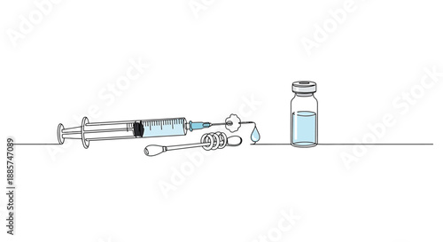 Medical syringe filled with clear blue liquid next to a small glass vial containing the same fluid on a white background