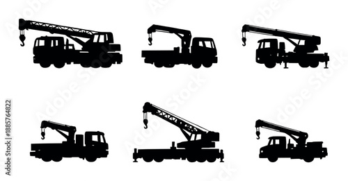 Silhouettes of construction cranes against dark gradient background