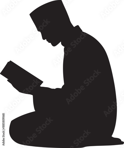 Silhouette of a man wearing a kufi hat reading a book while kneeling