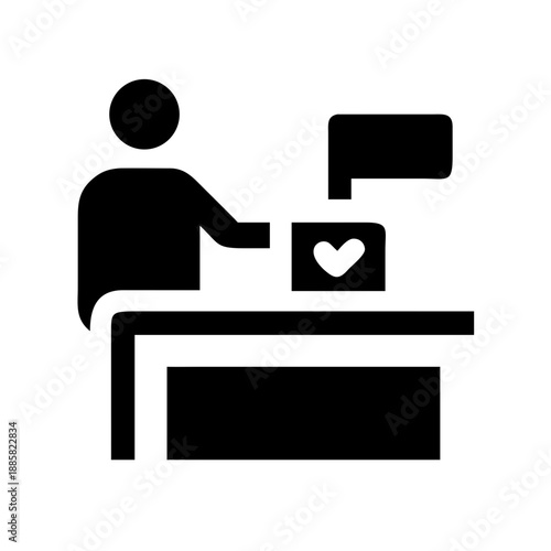 A simple black icon depicting a person sitting at a desk with a flag and a heart symbol on a computer, suggesting customer support or service with care.

