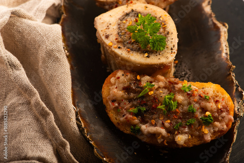 Roasted Bone Marrow with Spices and Baguette in Handmade Ceramic Bowl