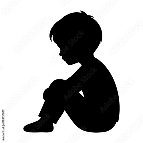 Black silhouette of a sad lonely boy sitting on the ground hugging knees