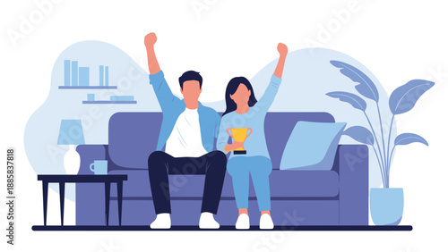 Excited young couple sitting on a sofa and cheering while holding a golden trophy to celebrate a victory or success together at home.