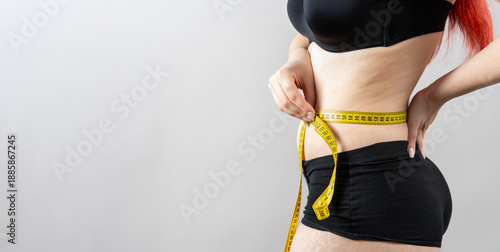 Billede på lærred Woman measuring waist with tape for weight loss