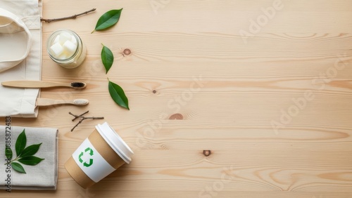 Overhead view of eco-friendly and zero-waste products for sustainable living, including natural personal care items on a light wooden surface