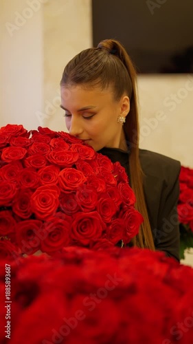 Wallpaper Mural Elegant woman holding a large bouquet of red roses. Romantic portrait concept. Torontodigital.ca