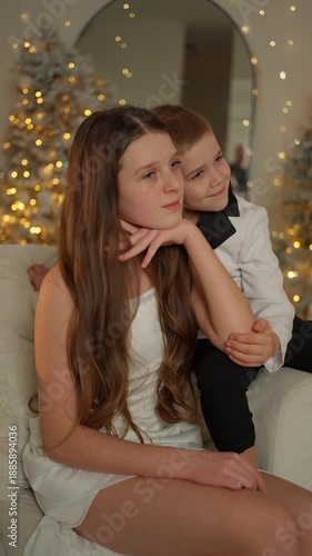 Wallpaper Mural Brother and sister sitting together in cozy Christmas living room. Family comfort concept. Torontodigital.ca