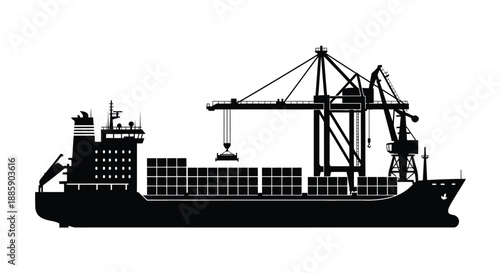 Silhouette of a cargo ship being loaded by a large port crane