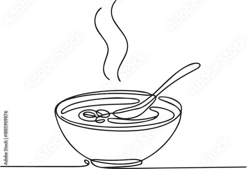 Steaming hot soup in a bowl with a spoon on a table