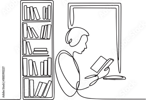 Man Reading a Book in a Quiet Library Setting with Bookshelves
