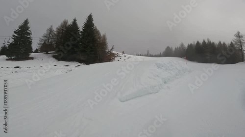 Freestyle Skier Performing Jump Trick in Winter Resort Folgaria Dolomites Italy Cloudy Day Slope
