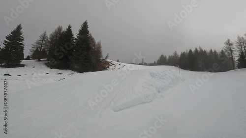 Freestyle Skier Performing Jump Trick in Winter Resort Folgaria Dolomites Italy Cloudy Day Slope