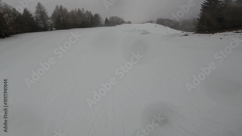 Freestyle Skier Performing Jump Trick in Winter Resort Folgaria Dolomites Italy Cloudy Day Slope