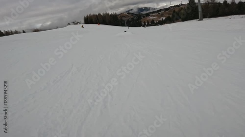 Freestyle Skier Performing Jump Trick in Winter Resort Folgaria Dolomites Italy Cloudy Day Slope
