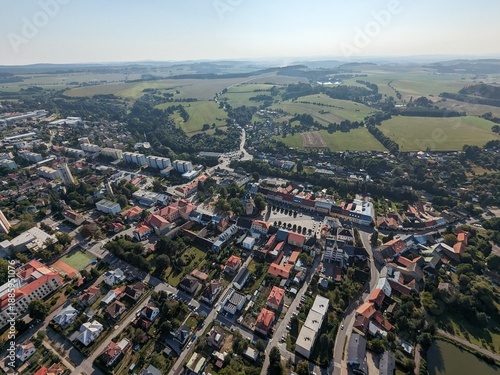 Aerial panorama of Nove Mesto na Morave showing town center, residential areas, and surrounding landscape in the Vysocina region, highlighting urban layout and natural setting