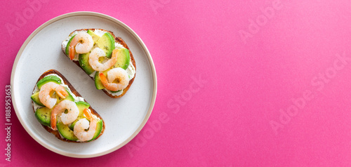 Fototapeta Bruschetta with shrimp, avocado, and white cream cheese