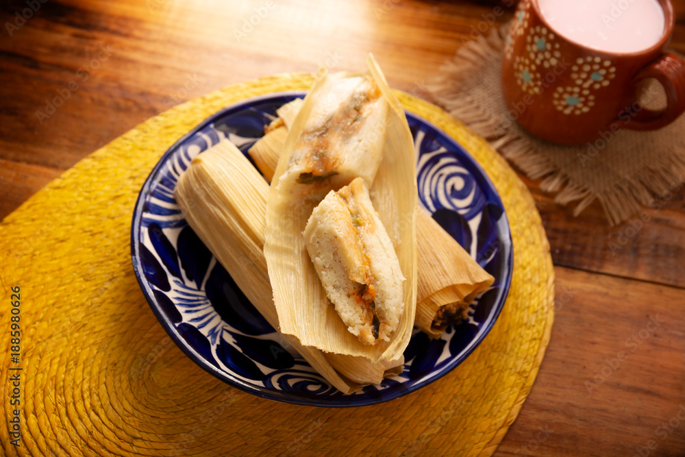 Fototapeta premium Tamales. Traditional dish typical of Mexico and some Latin American countries. Corn dough wrapped in corn leaves. The tamales are steamed.