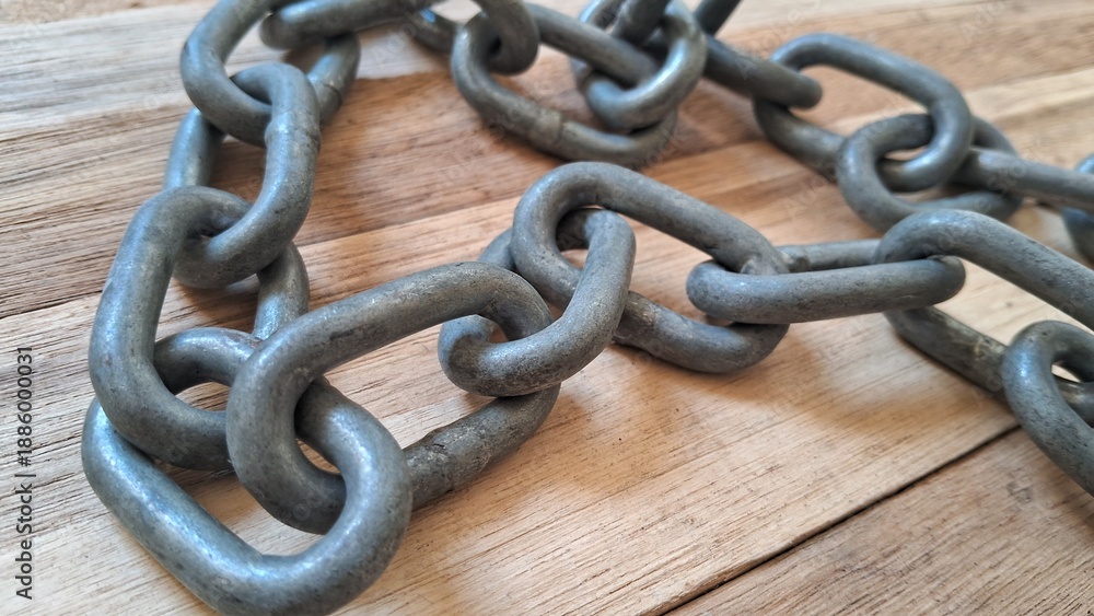 Fototapeta premium Rustic metal chain on wooden surface