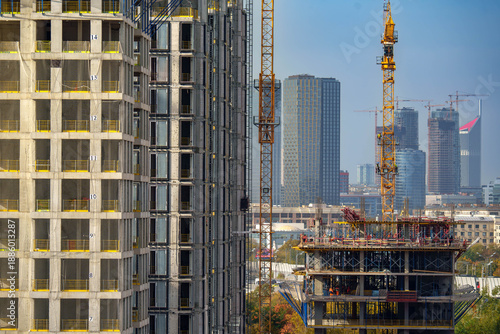 Photography Close-up of high-rise buildings under construction with city skyline