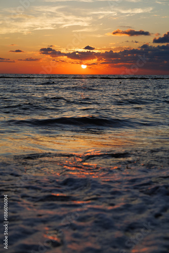 Sun rising over the horizon at sea in a beach at the Riviera Maya