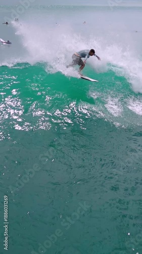 Surfer Riding Turquoise Wave Aerial View, Skillful Carve Along Barreling Face, Spray Erupting, Distant,Vertical video