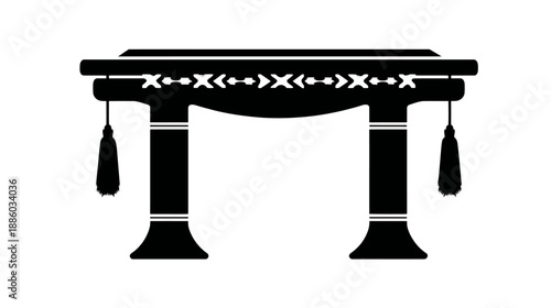 A simple, symmetrical black silhouette of a decorative structure with tassels and patterned trim