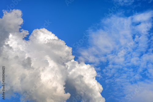 Dramatic deep blue sky with large fluffy white cumulus cloud formation