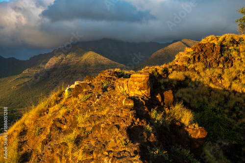 View from the Pink Pillbox lookout on the west coast of Oahu, Hawaii, overlooking the mountains, and dramatic clouds at sunset.