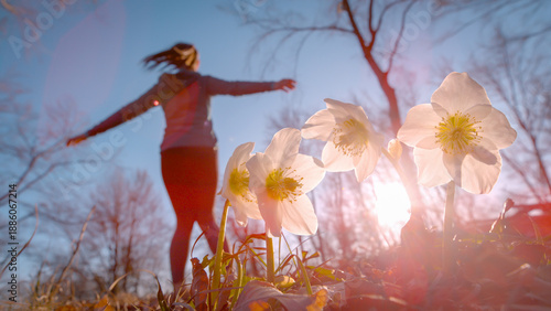 Tablou pe pânză DOF, LENS FLARE: Woman happily spinning and dancing in forest celebrating springtime