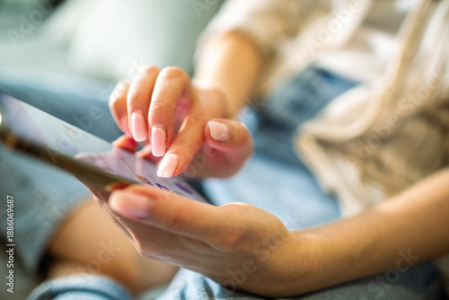 Woman using smartphone at home on couch