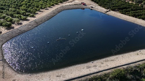 Aerial view of irrigation reservoir pond in agricultural farmland