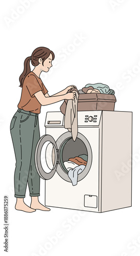 Young woman loading laundry into washing machine at home  