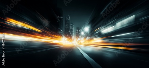 Urban city street at night showing speed and light trails. Blurring light streaking through a modern city street at night conveying fast motion