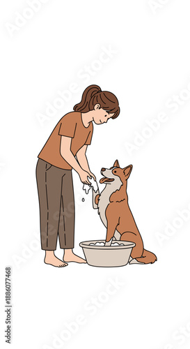 Young woman bathing dog in a bowl during home grooming session  
