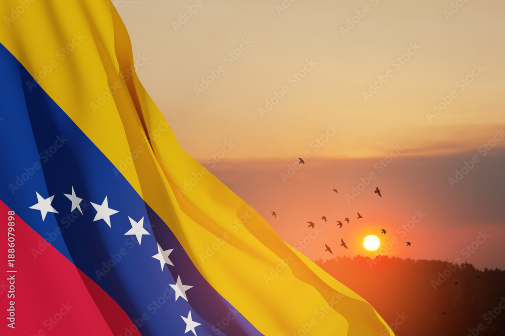 Obraz premium Venezuela flag on background of sunset sky with flying birds. Patriotic concept. Banner with place for text.